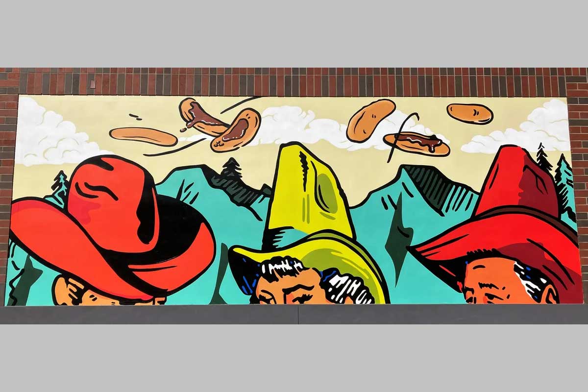 Mural of cowboy hats and flying flapjacks.